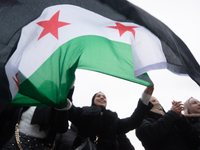 More than a hundred people celebrate post Al Assad in front of Duisburg Central Station in Duisburg, Germany, on December 10, 2024. (