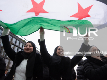 More than a hundred people celebrate post Al Assad in front of Duisburg Central Station in Duisburg, Germany, on December 10, 2024. (