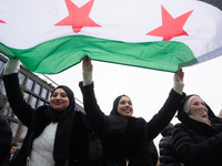 More than a hundred people celebrate post Al Assad in front of Duisburg Central Station in Duisburg, Germany, on December 10, 2024. (