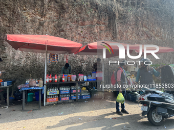 People sell drinks and snacks along the roadside in Punalur, Kollam, Kerala, India, on April 4, 2024. (