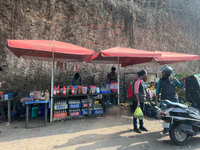 People sell drinks and snacks along the roadside in Punalur, Kollam, Kerala, India, on April 4, 2024. (