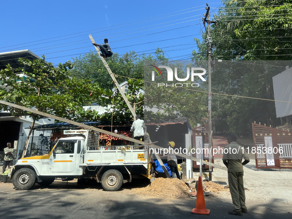 Workers install new electricity poles in Kottarakkara, Kollam, Kerala, India, on April 6, 2024. 