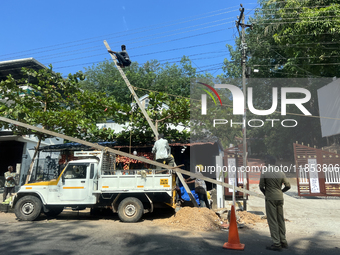 Workers install new electricity poles in Kottarakkara, Kollam, Kerala, India, on April 6, 2024. (