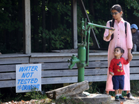 A young girl from India looks at an antique water pump at a farm in Stouffville, Ontario, Canada, on September 22, 2024. (