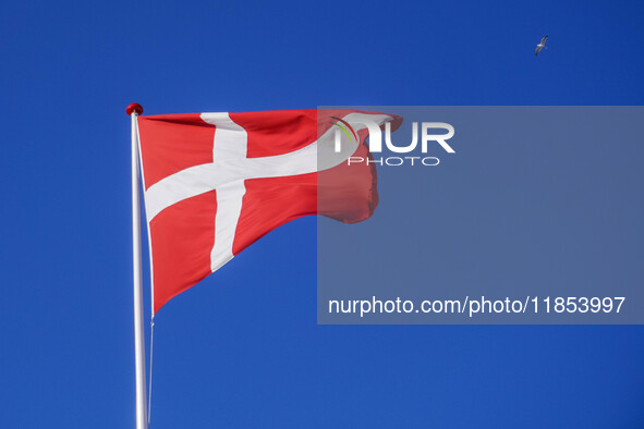 The flag of Denmark is seen blowing in the wind in Nordby, Fano Island, Denmark, on April 29, 2024. 