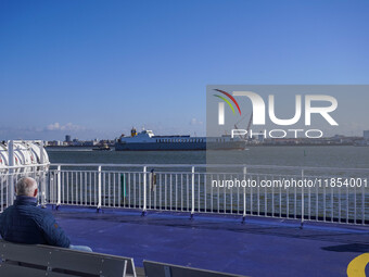 People look at the ships in Esbjerg port in Nordby, Fano Island, Denmark, on April 29, 2024. (