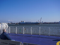 People look at the ships in Esbjerg port in Nordby, Fano Island, Denmark, on April 29, 2024. (