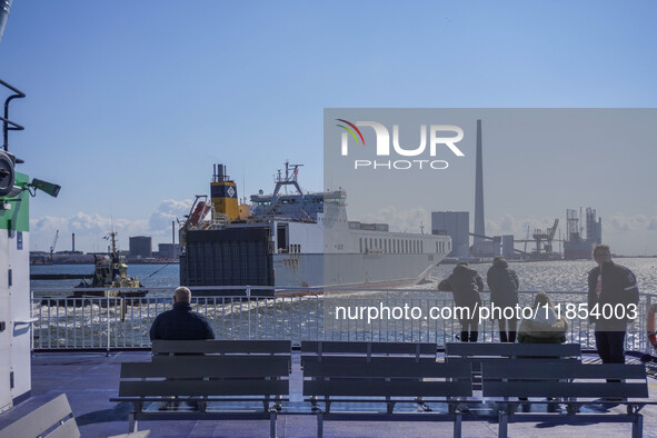 People look at the ships in Esbjerg port in Nordby, Fano Island, Denmark, on April 29, 2024. 