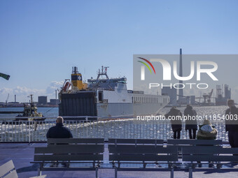 People look at the ships in Esbjerg port in Nordby, Fano Island, Denmark, on April 29, 2024. (