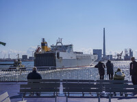 People look at the ships in Esbjerg port in Nordby, Fano Island, Denmark, on April 29, 2024. (