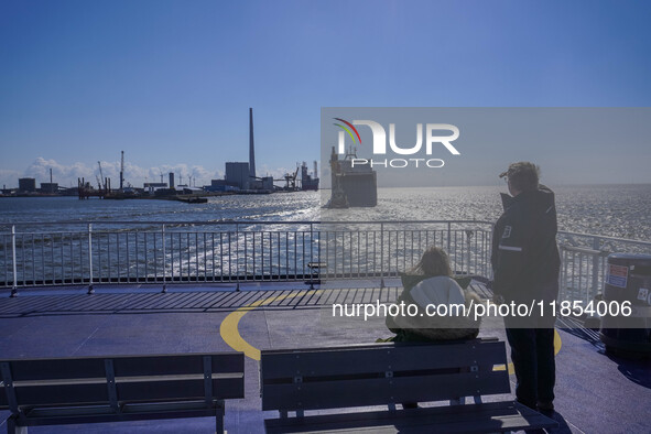 People look at the ships in Esbjerg port in Nordby, Fano Island, Denmark, on April 29, 2024. 