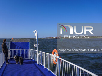 A man with his dog stands waiting on the ferry in Esbjerg, Denmark, on April 29, 2024. (