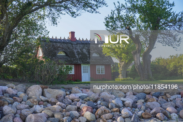 An old Danish wooden house with a thatched roof is on the seashore in Kongebro Middelfart, Fyn, Denmark, on May 3, 2024. 