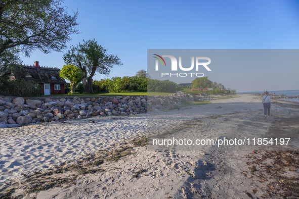 An old Danish wooden house with a thatched roof is on the seashore in Kongebro Middelfart, Fyn, Denmark, on May 3, 2024. 