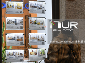 KRAKOW, POLAND - DECEMBER 10:   
A woman looks at a window displaying advertisements for properties at a local real estate office in the his...