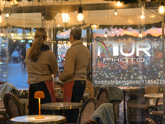 KRAKOW, POLAND - DECEMBER 10:   
Two waitresses wait for customers inside a restaurant terrace on Krakow’s UNESCO-listed Market Square, on D...