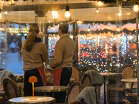 KRAKOW, POLAND - DECEMBER 10:   
Two waitresses wait for customers inside a restaurant terrace on Krakow’s UNESCO-listed Market Square, on D...