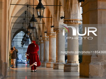 KRAKOW, POLAND - DECEMBER 10:   
A Santa busker walks through the Cloth Hall in Krakow’s UNESCO-listed Market Square, on December 10, 2024 i...