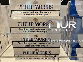 Cartons of cigarettes are at a duty-free shop at Zayed International Airport in Abu Dhabi, United Arab Emirates, on March 28, 2024. (