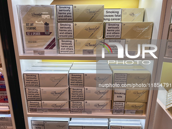 Cartons of cigarettes are at a duty-free shop at Zayed International Airport in Abu Dhabi, United Arab Emirates, on March 28, 2024. (