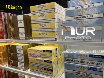 Cartons of cigarettes are at a duty-free shop at Zayed International Airport in Abu Dhabi, United Arab Emirates, on March 28, 2024. (