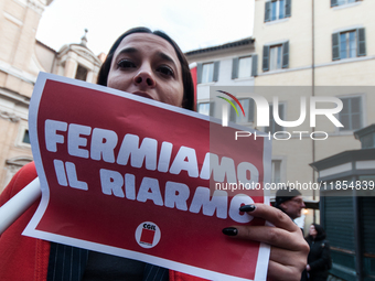 Pacifists protest against the increase in military spending and in favor of human rights in Piazza Capranica near the Chamber of Deputies Pi...