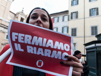 Pacifists protest against the increase in military spending and in favor of human rights in Piazza Capranica near the Chamber of Deputies Pi...