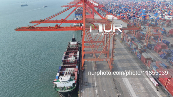 Large cargo ships are loaded at Qinzhou Automated Container Terminal in Beiwan Port, South China's Guangxi Zhuang Autonomous Region, on Dece...