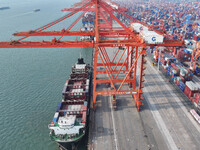 Large cargo ships are loaded at Qinzhou Automated Container Terminal in Beiwan Port, South China's Guangxi Zhuang Autonomous Region, on Dece...