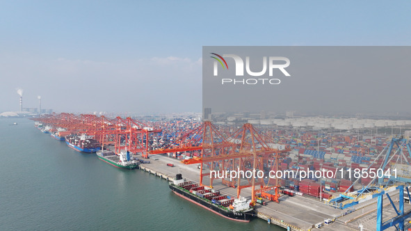 Large cargo ships are loaded at Qinzhou Automated Container Terminal in Beiwan Port, South China's Guangxi Zhuang Autonomous Region, on Dece...