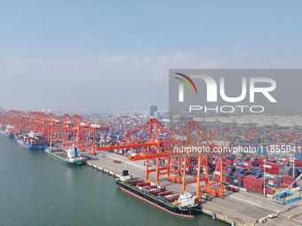 Large cargo ships are loaded at Qinzhou Automated Container Terminal in Beiwan Port, South China's Guangxi Zhuang Autonomous Region, on Dece...