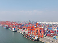 Large cargo ships are loaded at Qinzhou Automated Container Terminal in Beiwan Port, South China's Guangxi Zhuang Autonomous Region, on Dece...