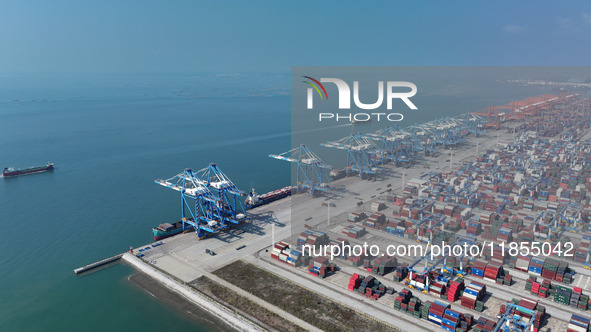 Large cargo ships are loaded at Qinzhou Automated Container Terminal in Beiwan Port, South China's Guangxi Zhuang Autonomous Region, on Dece...