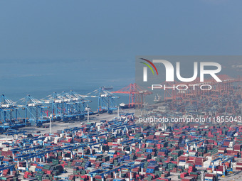 Large cargo ships are loaded at Qinzhou Automated Container Terminal in Beiwan Port, South China's Guangxi Zhuang Autonomous Region, on Dece...