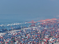 Large cargo ships are loaded at Qinzhou Automated Container Terminal in Beiwan Port, South China's Guangxi Zhuang Autonomous Region, on Dece...