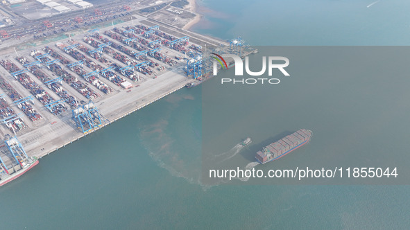 A cargo ship departs from the port after being loaded at Qinzhou Automated Container Terminal in Beiwan Port, South China's Guangxi Zhuang A...