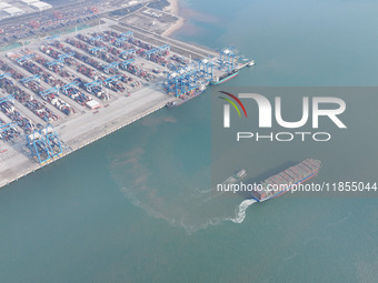 A cargo ship departs from the port after being loaded at Qinzhou Automated Container Terminal in Beiwan Port, South China's Guangxi Zhuang A...