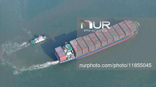 A cargo ship departs from the port after being loaded at Qinzhou Automated Container Terminal in Beiwan Port, South China's Guangxi Zhuang A...