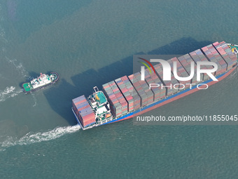 A cargo ship departs from the port after being loaded at Qinzhou Automated Container Terminal in Beiwan Port, South China's Guangxi Zhuang A...