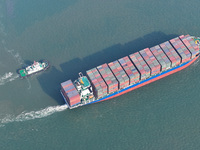 A cargo ship departs from the port after being loaded at Qinzhou Automated Container Terminal in Beiwan Port, South China's Guangxi Zhuang A...