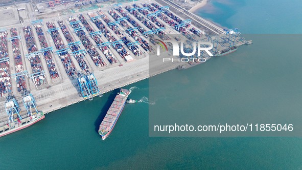 A cargo ship departs from the port after being loaded at Qinzhou Automated Container Terminal in Beiwan Port, South China's Guangxi Zhuang A...