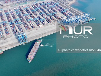 A cargo ship departs from the port after being loaded at Qinzhou Automated Container Terminal in Beiwan Port, South China's Guangxi Zhuang A...