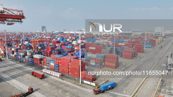 The trucks transport containers into the port at Qinzhou Automated Container Terminal in Beiwan Port, South China's Guangxi Zhuang Autonomou...