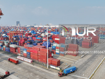 The trucks transport containers into the port at Qinzhou Automated Container Terminal in Beiwan Port, South China's Guangxi Zhuang Autonomou...