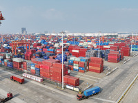 The trucks transport containers into the port at Qinzhou Automated Container Terminal in Beiwan Port, South China's Guangxi Zhuang Autonomou...