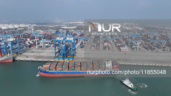 A cargo ship departs from the port after being loaded at Qinzhou Automated Container Terminal in Beiwan Port, South China's Guangxi Zhuang A...