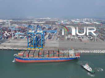 A cargo ship departs from the port after being loaded at Qinzhou Automated Container Terminal in Beiwan Port, South China's Guangxi Zhuang A...