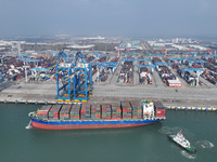 A cargo ship departs from the port after being loaded at Qinzhou Automated Container Terminal in Beiwan Port, South China's Guangxi Zhuang A...