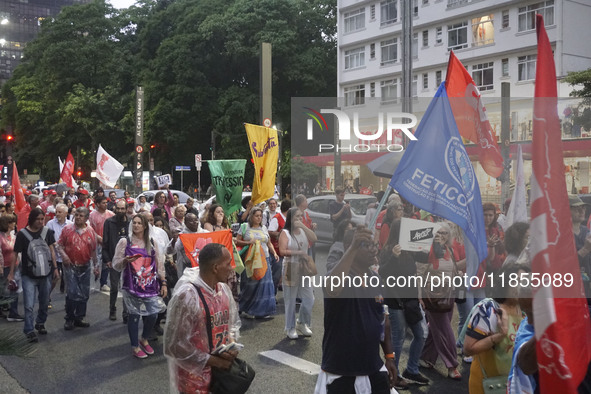 Demonstrators hold banners demanding the imprisonment of Brazilian former President Jair Bolsonaro during a protest in defense of democracy...