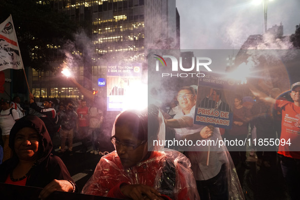 Demonstrators hold banners demanding the imprisonment of Brazilian former President Jair Bolsonaro during a protest in defense of democracy...